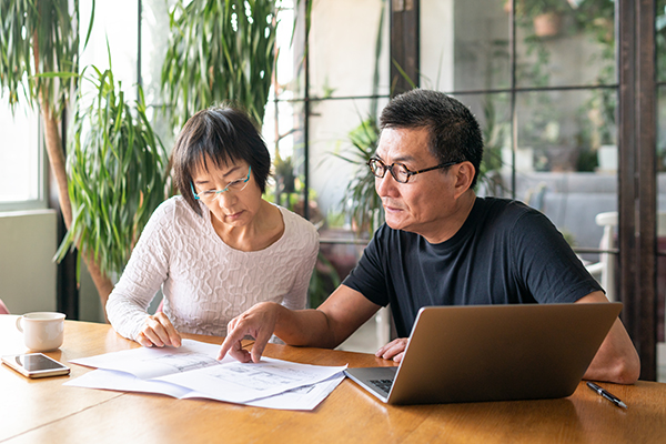 Asian couple discussing researching finance