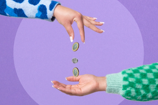 Hand dropping coins into another hand