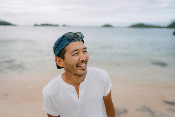 Happy asian man at the beach