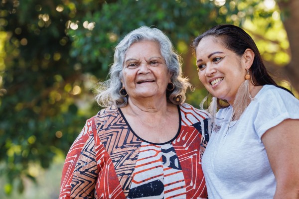 image of mature mother and adult daughter in park