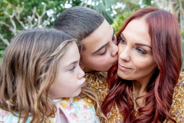 image of woman with two children in a garden