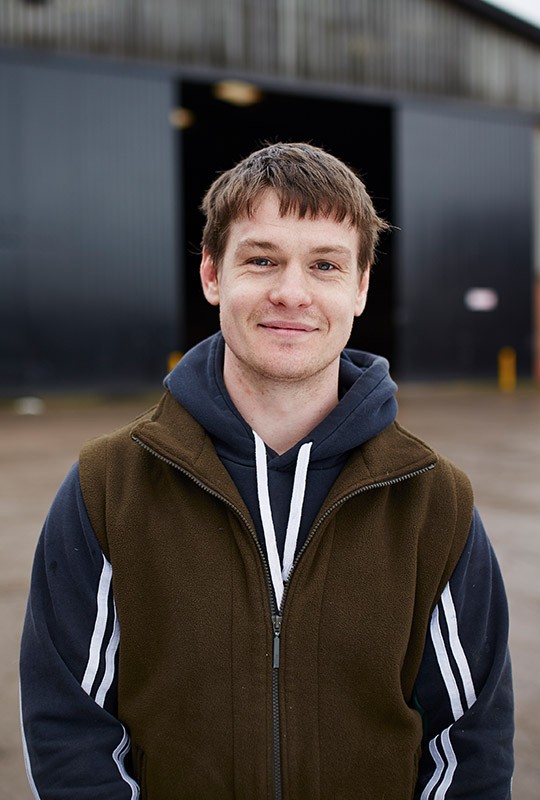 young-man-standing-in-front-of-a-warehouse-540x800