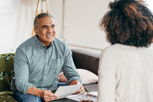 Man talking to an adviser holding paperwork