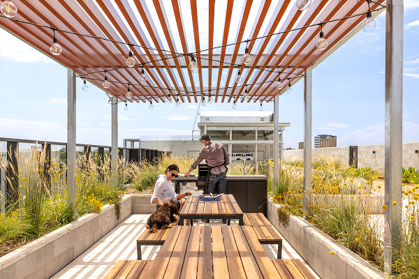 An image of two people barbequing outdoors
