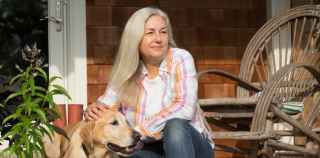 Image of senior woman sitting with dog