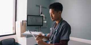 Image of health worker checking data