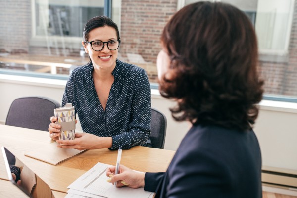 Two women discussing finance
