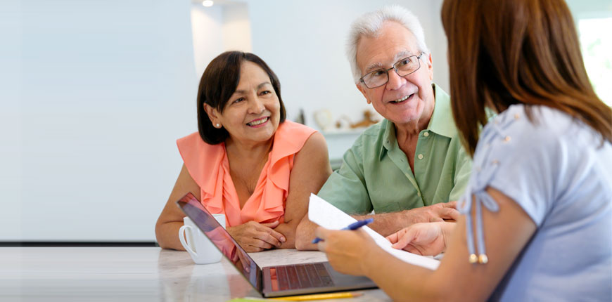 senior couple talking to adviser retirement income stream